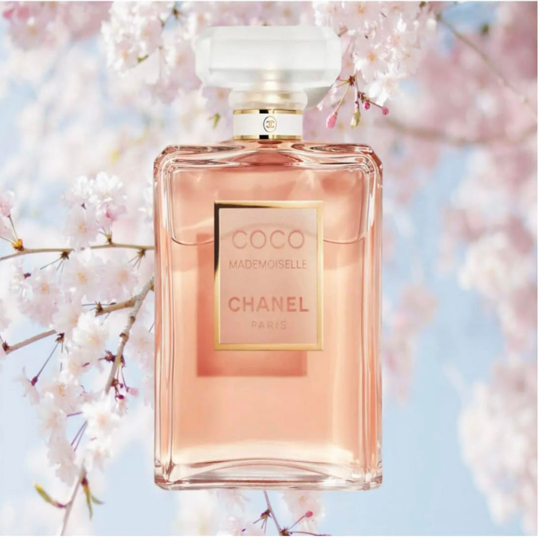 Chanel perfume bottle with cherry blossoms in the background