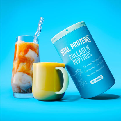 Vital Proteins Collagen Peptides container with a colorful drink and mug on a blue background