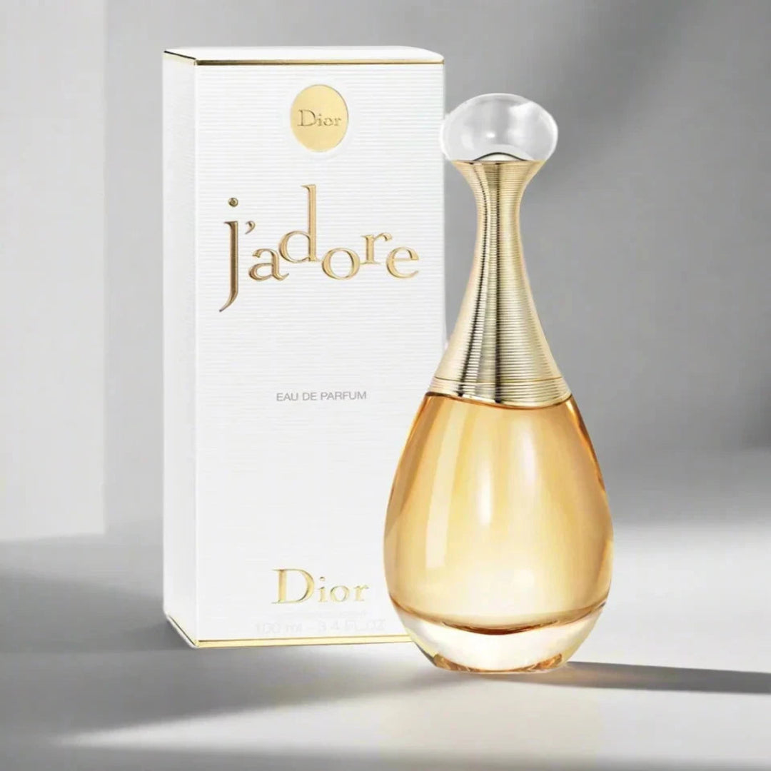Dior j'adore perfume bottle and packaging on a gray background