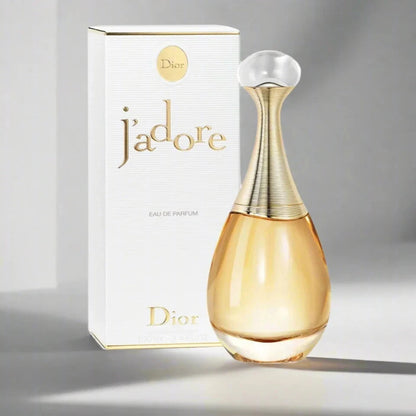Dior j'adore perfume bottle and packaging on a gray background