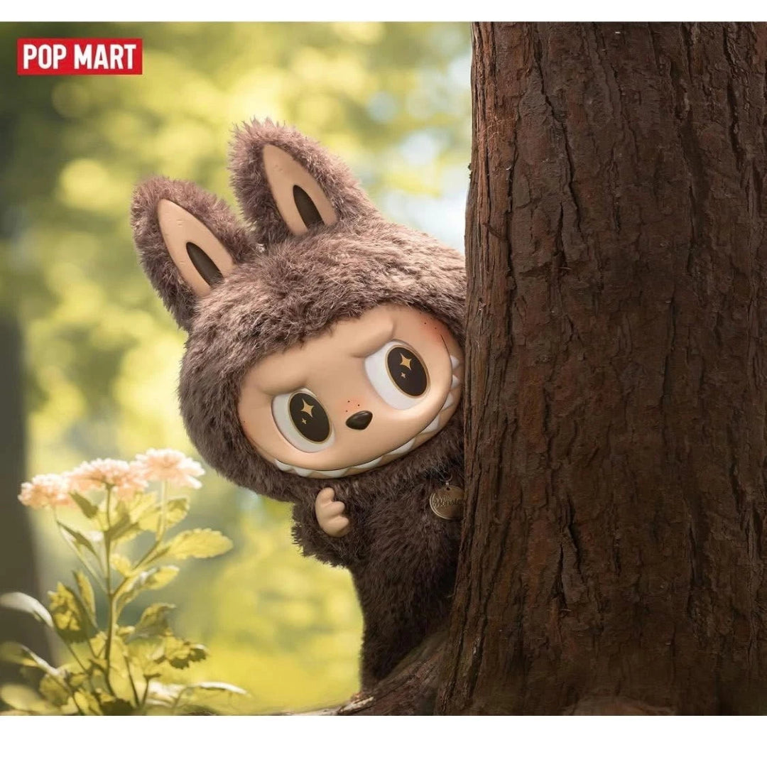 Plush toy with animal ears peeking from behind a tree in a natural setting