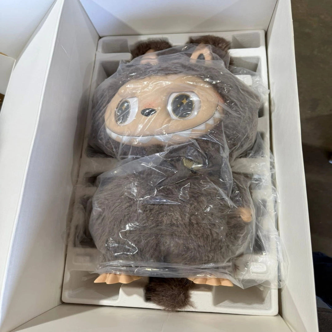 Plush toy in a box with plastic wrap, likely new or unused