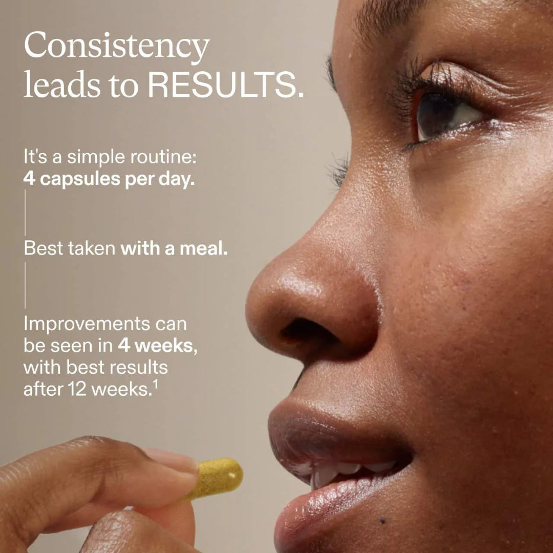 Person taking a supplement capsule with text about consistency leading to results on a beige background
